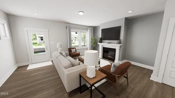 a living room with furniture a flat screen tv and a fireplace