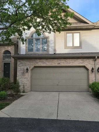 a front view of a house with garage