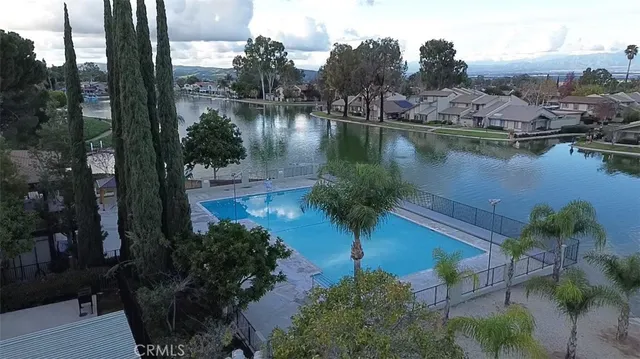 an aerial view of residential house with outdoor space and lake view