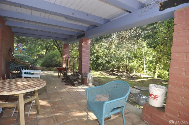 a backyard of a house with outdoor seating