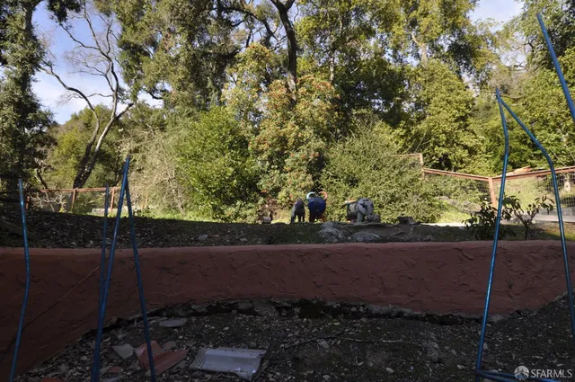 a view of a patio with table and chairs and potted plants