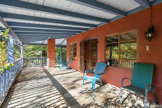 a balcony with furniture and a potted plant