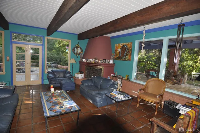 a outdoor living space with furniture potted plant and a large window