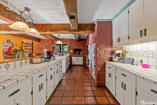 a kitchen with stainless steel appliances kitchen island granite countertop lots of counter top space and wooden floor