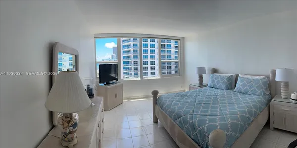 a bedroom with a bed and glass window