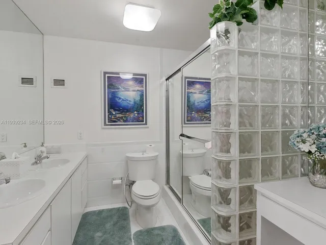a bathroom with a toilet sink and shower