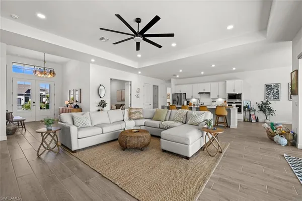a living room with furniture and view of kitchen