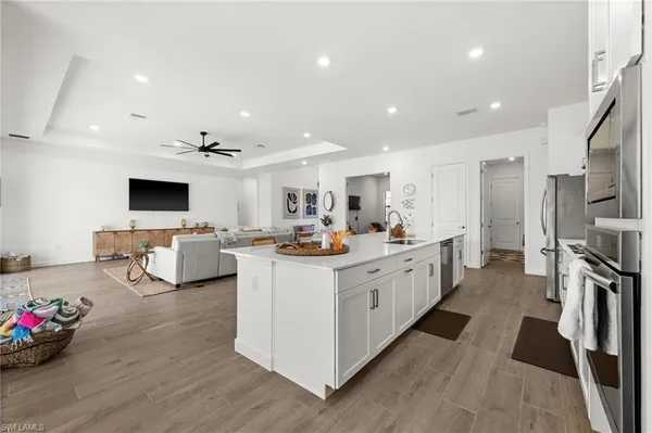 a large white kitchen with a large window