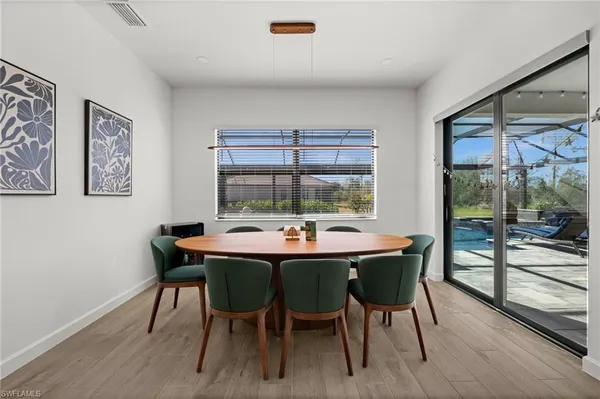 a dining room with furniture a rug and wooden floor
