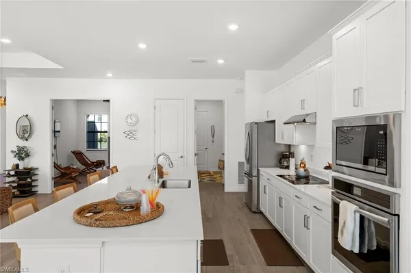 a kitchen with stainless steel appliances kitchen island granite countertop a sink stove and refrigerator