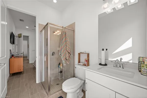 a bathroom with a toilet a sink and a mirror