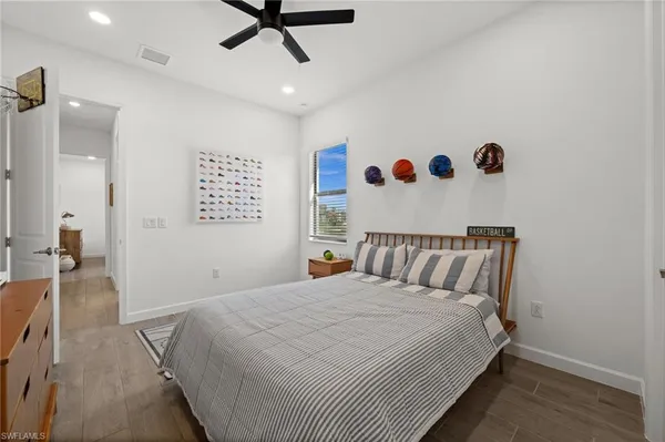 a bedroom with a large bed and a chandelier