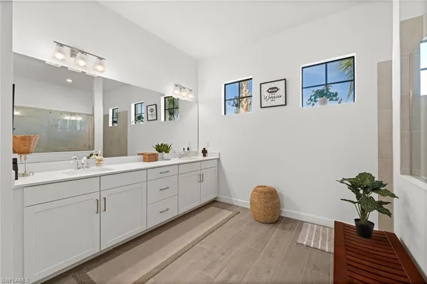 a spacious bathroom with double sink and a mirror