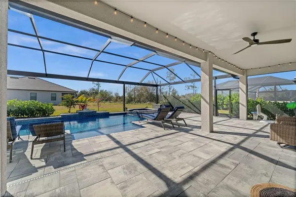 a view of a patio with a table and chairs under an umbrella