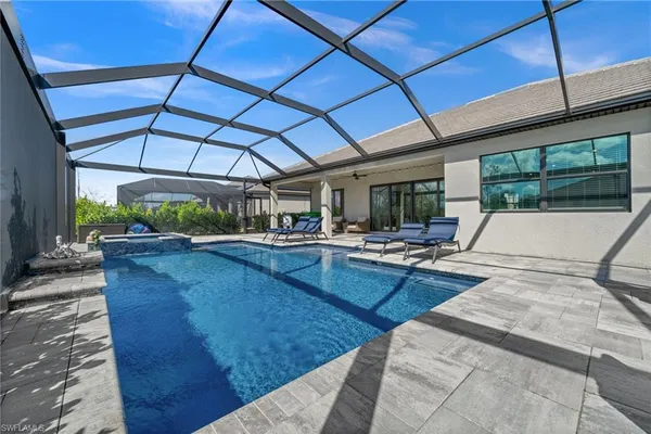a view of swimming pool with outdoor seating