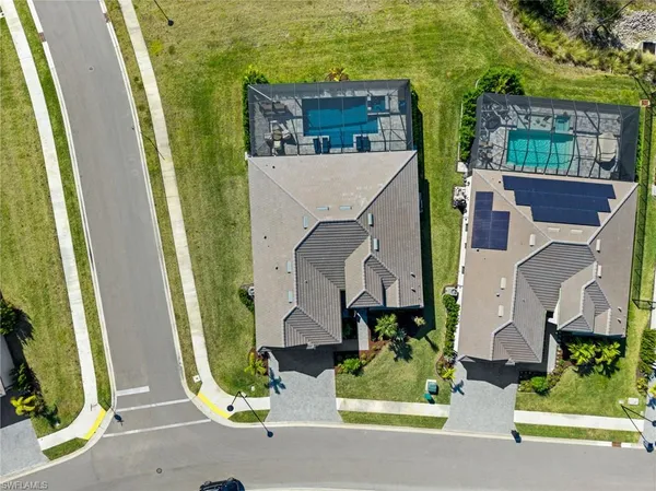 an aerial view of a house with a yard and potted plants