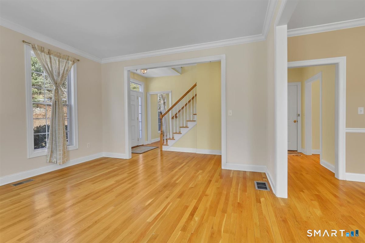 25 Fenwick Drive Avon, CT 06001 - Photo 18 of 40 a view of an empty room with wooden floor and a window
