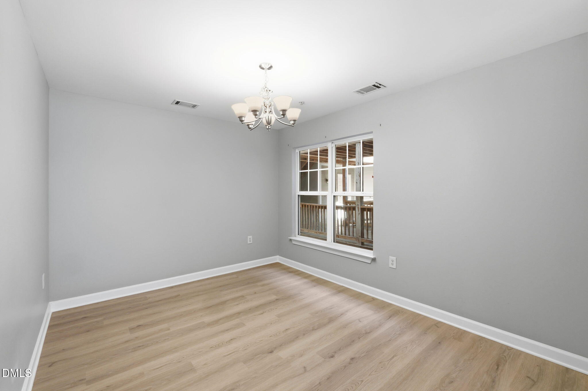 929 Morreene Road, Unit A23 Durham, NC 27705 - Photo 10 of 41 an empty room with wooden floor and windows