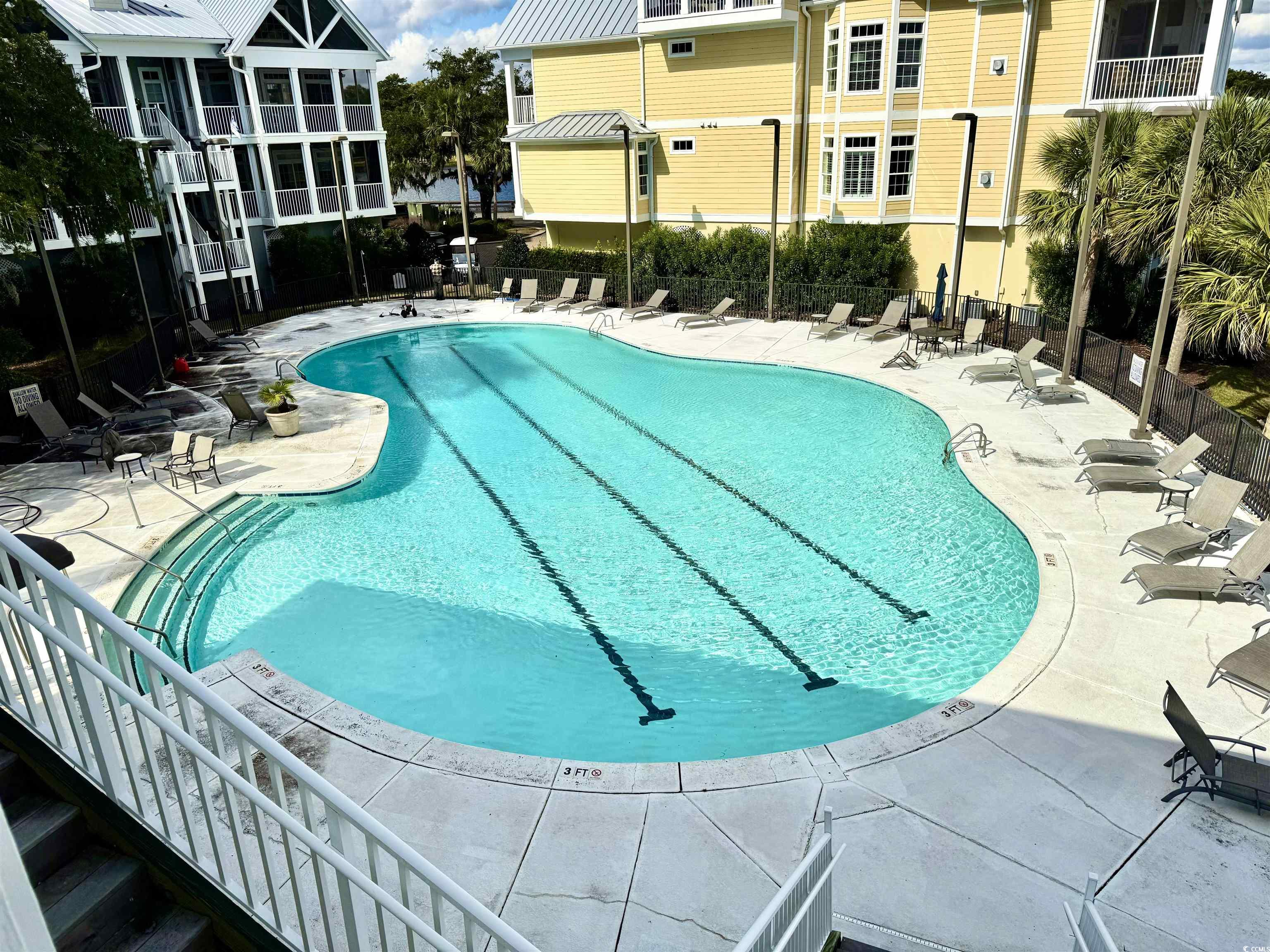 31 Battery White Court, Unit 1005 Georgetown, SC 29440 - Photo 24 of 34 Community pool featuring a patio area