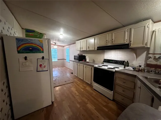 a kitchen with a sink a stove and cabinets