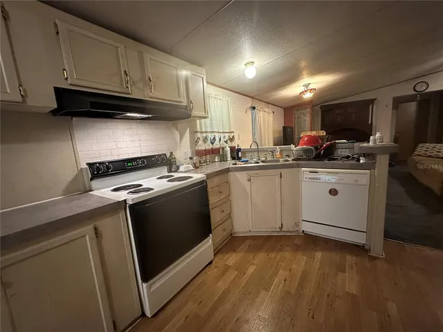 a kitchen with lots of counter top space and refrigerator