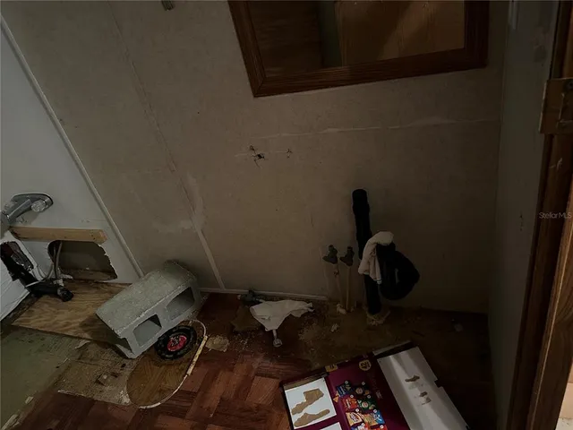 a room with furniture a air conditioner vent and a window