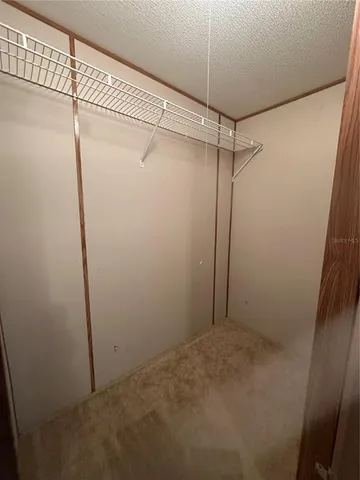 a view of a yard with trees in the background