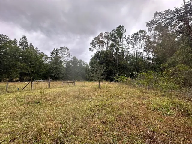 a view of outdoor space with deck and yard