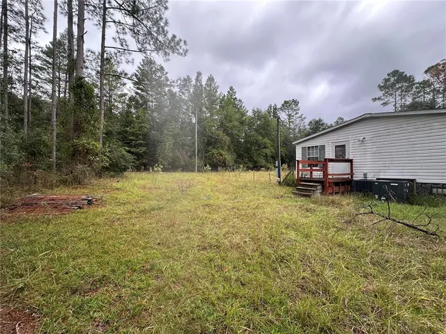 a backyard of a house with lots of green space
