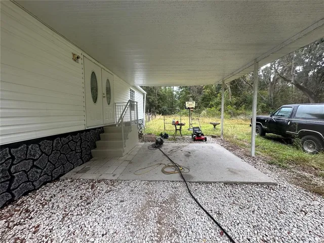a car parked in front of a house with a yard