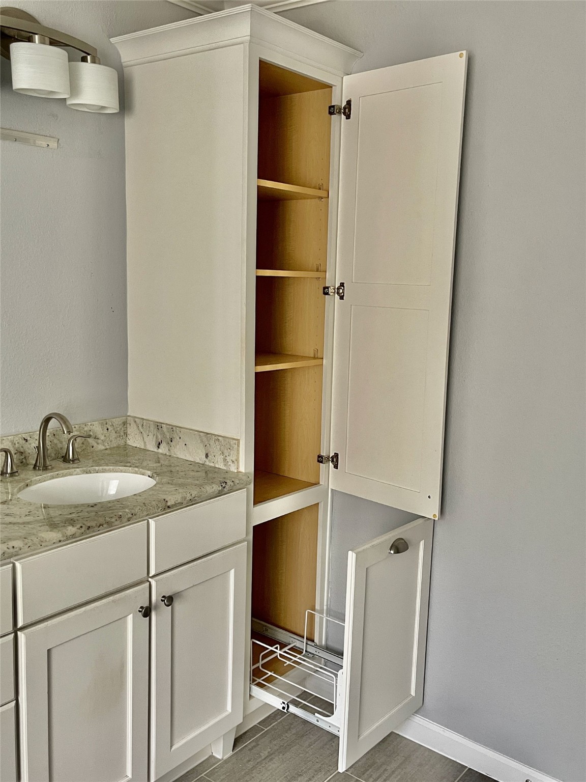 6674 Sylvan Road Houston, TX 77023 - Photo 11 of 17 a bathroom with a granite countertop sink and a mirror