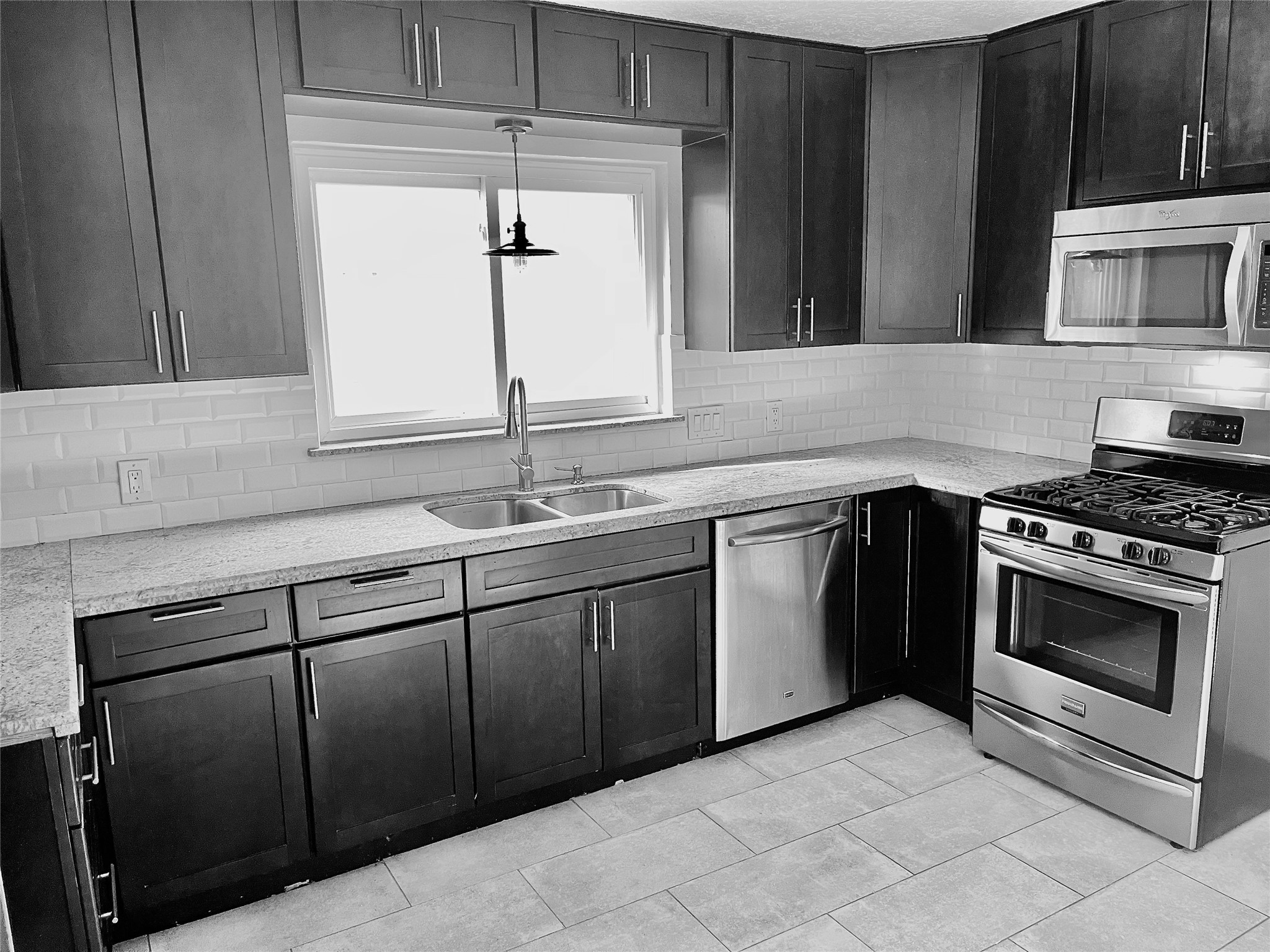 6674 Sylvan Road Houston, TX 77023 - Photo 4 of 17 a kitchen with a sink stove and microwave