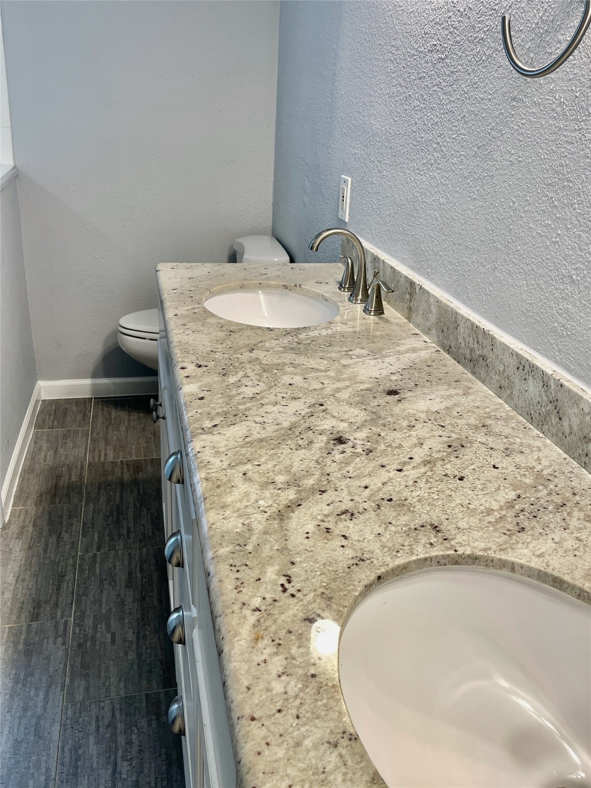 6674 Sylvan Road Houston, TX 77023 - Photo 9 of 17 a bathroom with a granite countertop sink and a mirror