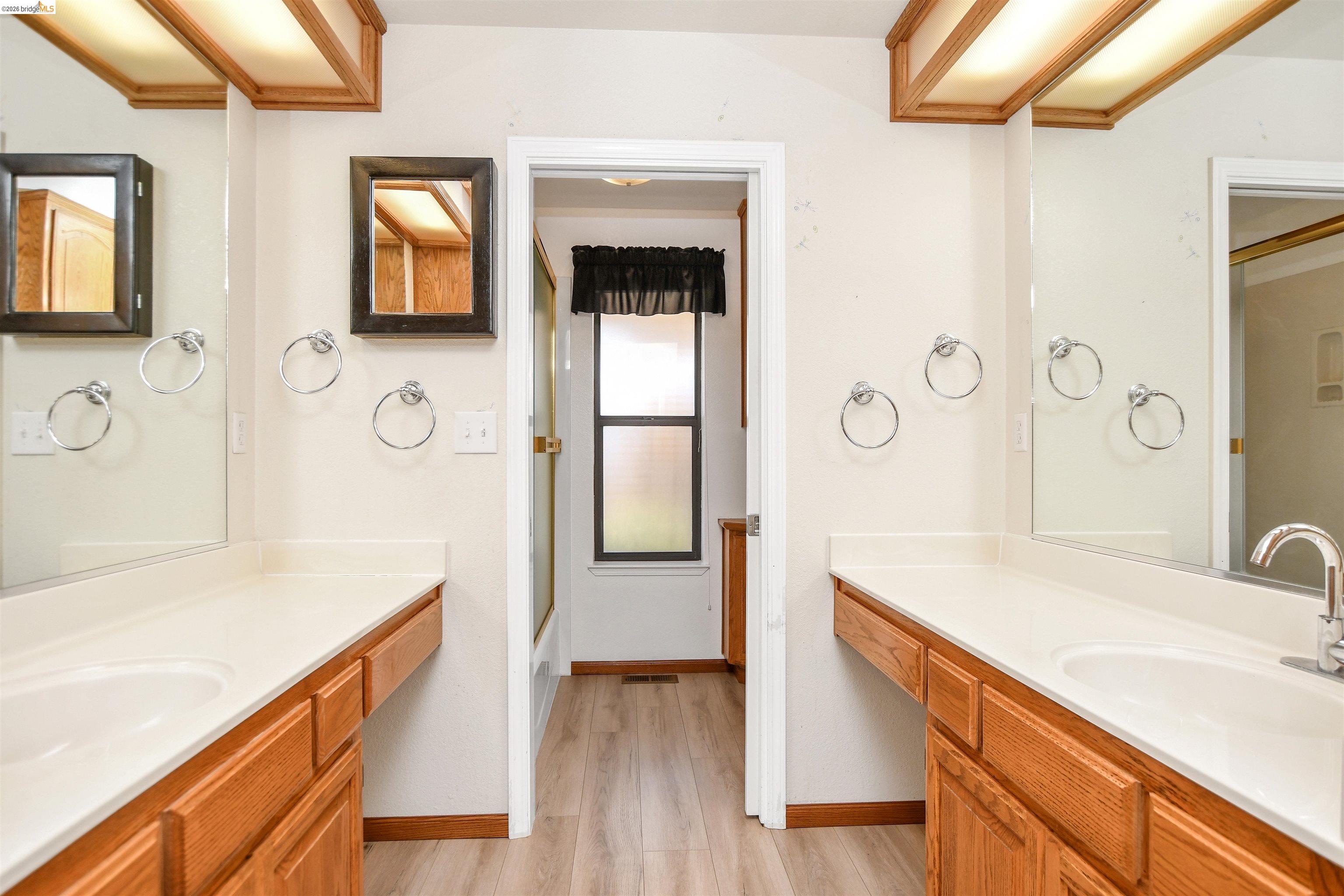 23751 Marsh Creek Road Brentwood, CA 94513 - Photo 17 of 49 a bathroom with a sink a vanity and a mirror