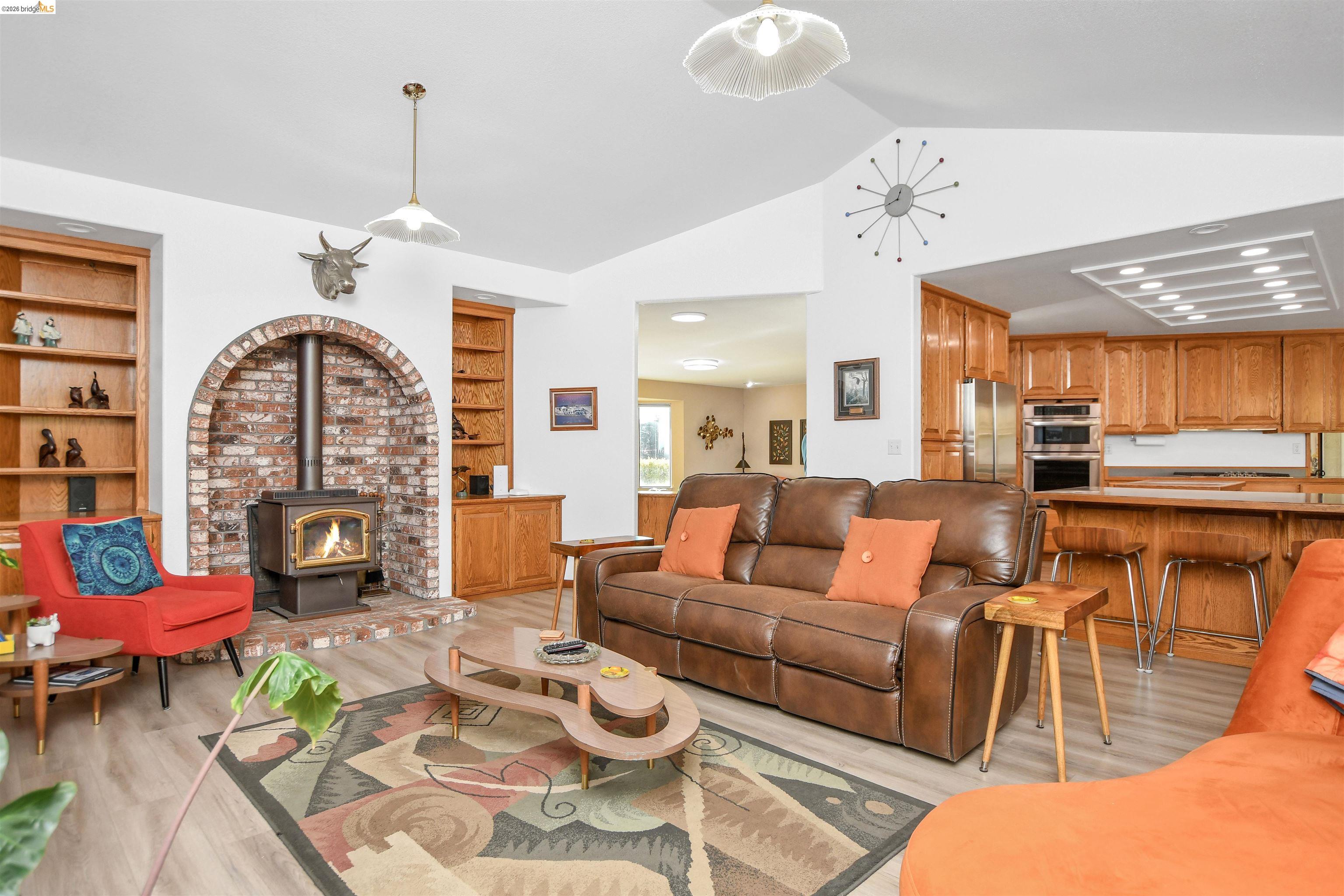 23751 Marsh Creek Road Brentwood, CA 94513 - Photo 18 of 49 a living room with furniture a fireplace and a chandelier