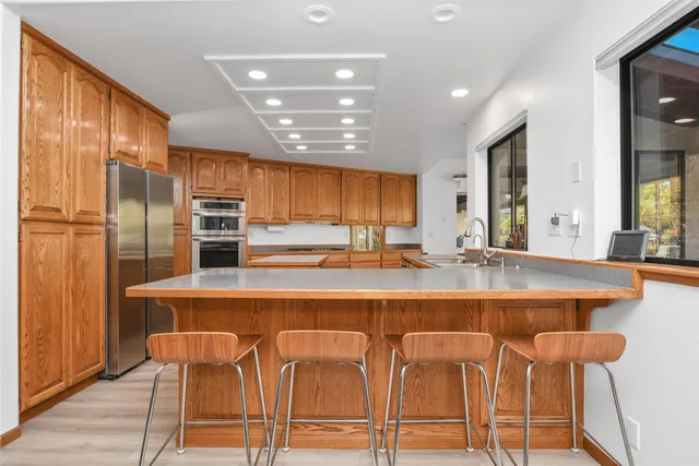 a large kitchen with lots of counter space a sink and appliances