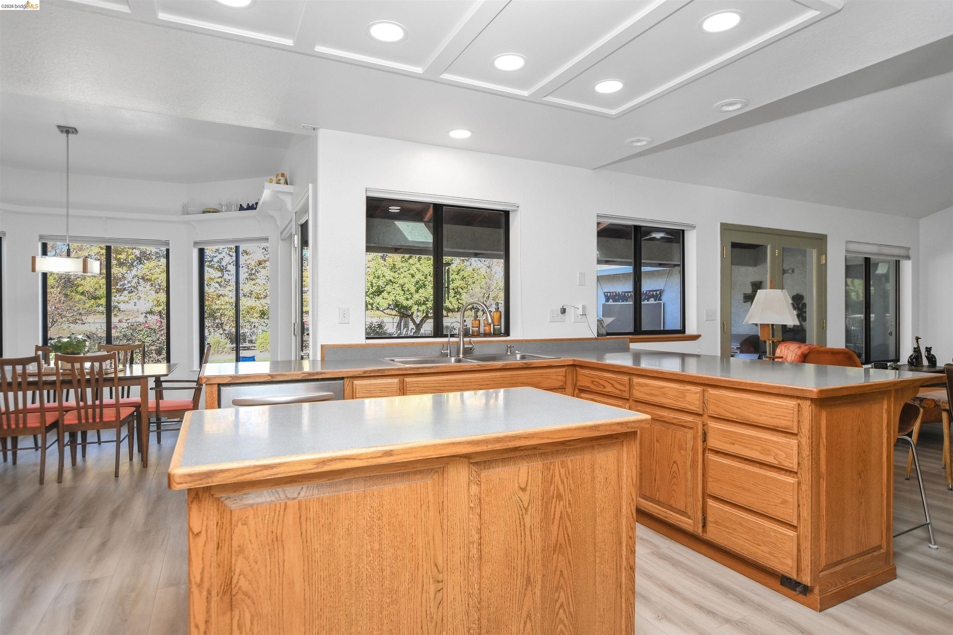 23751 Marsh Creek Road Brentwood, CA 94513 - Photo 21 of 49 a view of a kitchen counter top space with wooden floor and stainless steel appliances