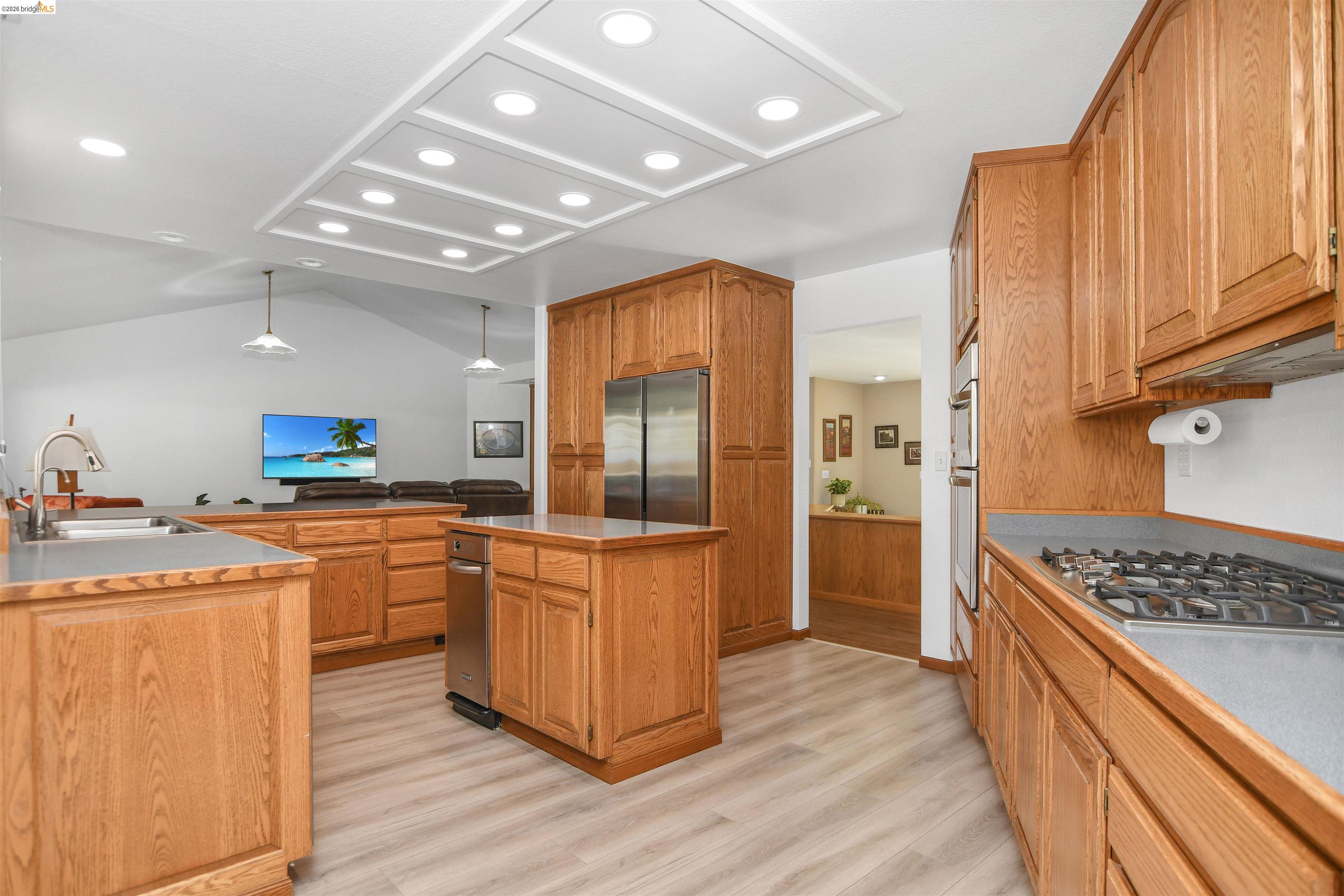 23751 Marsh Creek Road Brentwood, CA 94513 - Photo 23 of 49 a kitchen with stainless steel appliances granite countertop a stove a sink dishwasher a refrigerator and wooden cabinets with wooden floor