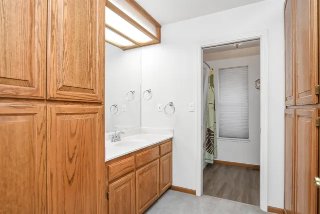 a bedroom with bed couch and window