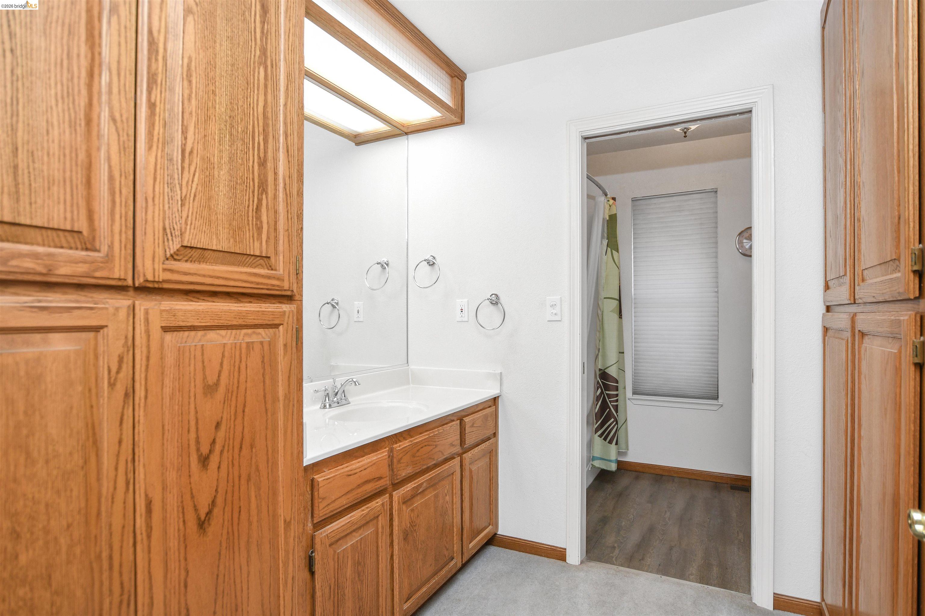 23751 Marsh Creek Road Brentwood, CA 94513 - Photo 25 of 49 a bathroom with a granite countertop sink and a mirror