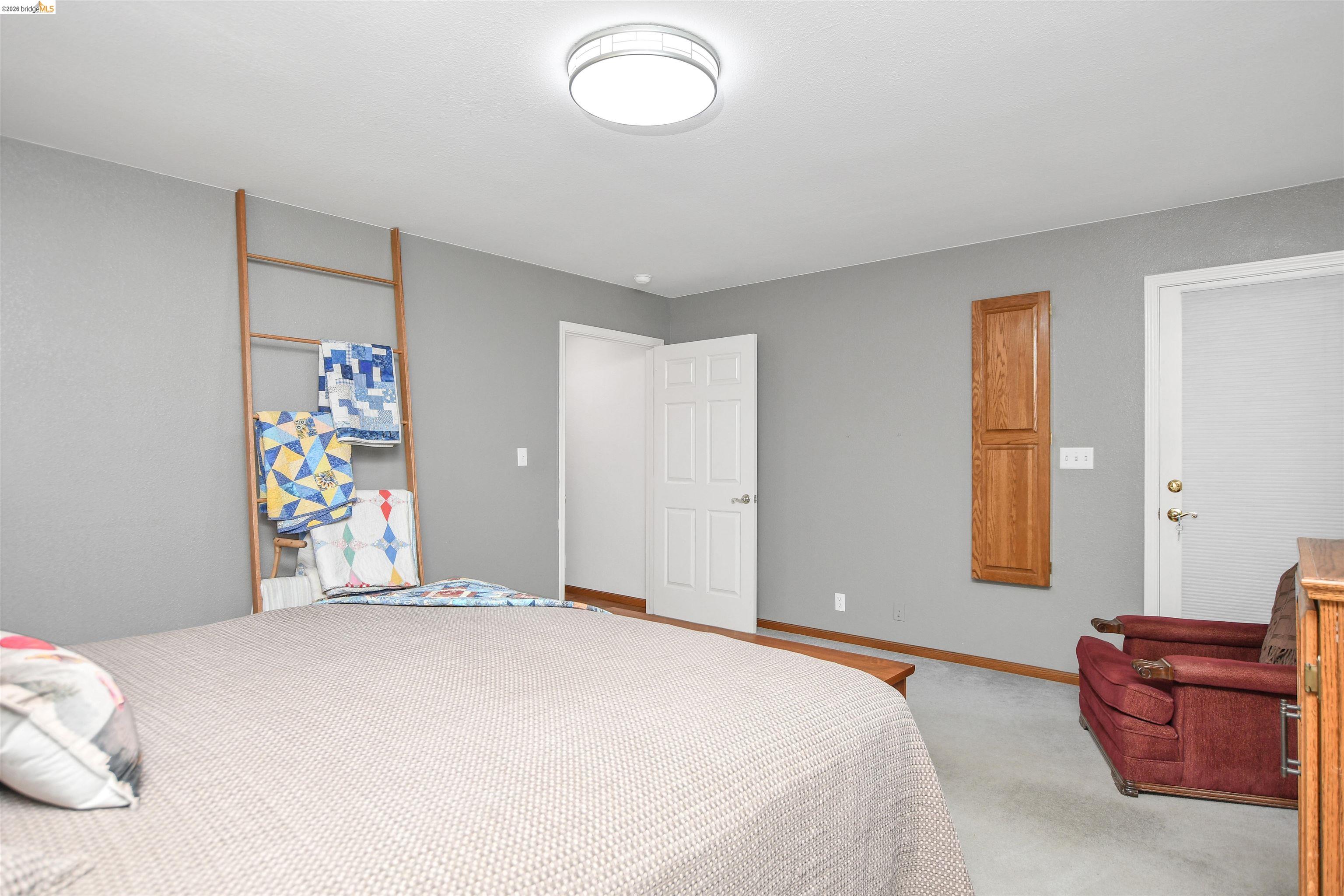23751 Marsh Creek Road Brentwood, CA 94513 - Photo 27 of 49 a bedroom with a bed and a couch