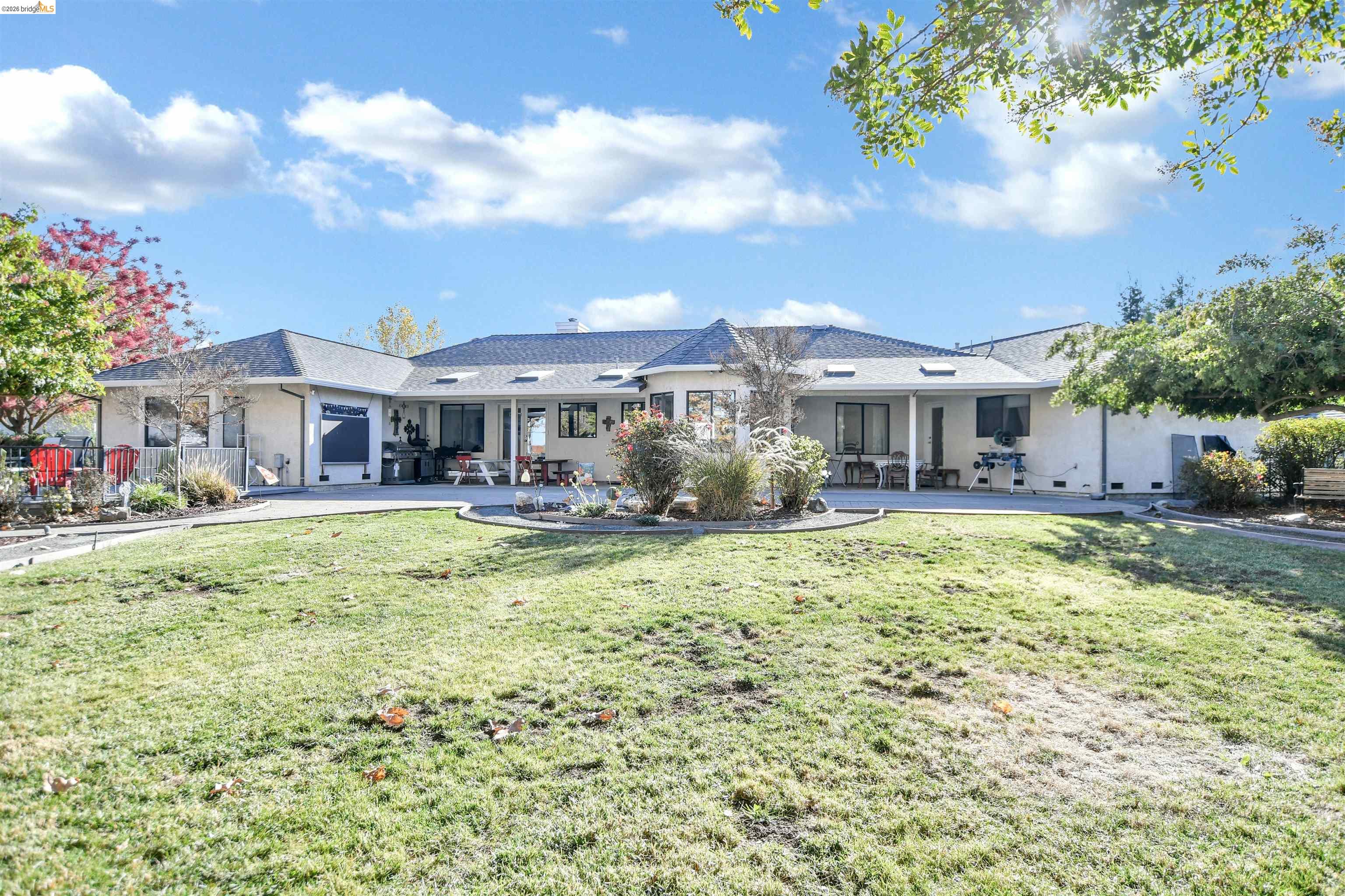23751 Marsh Creek Road Brentwood, CA 94513 - Photo 34 of 49 a view of a house with a big yard and potted plants