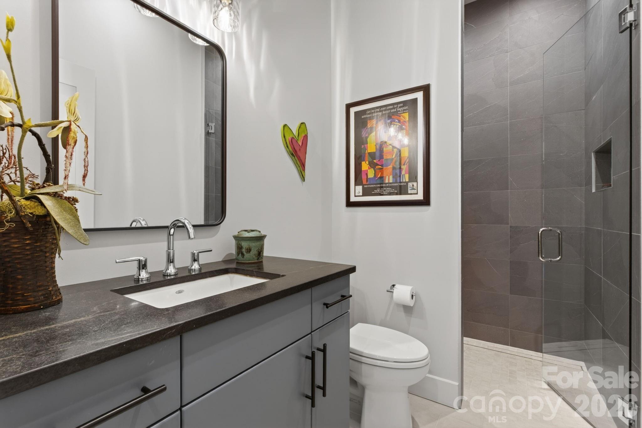18 Wordsworth Road Black Mountain, NC 28711 - Photo 14 of 23 a bathroom with a granite countertop toilet sink and mirror