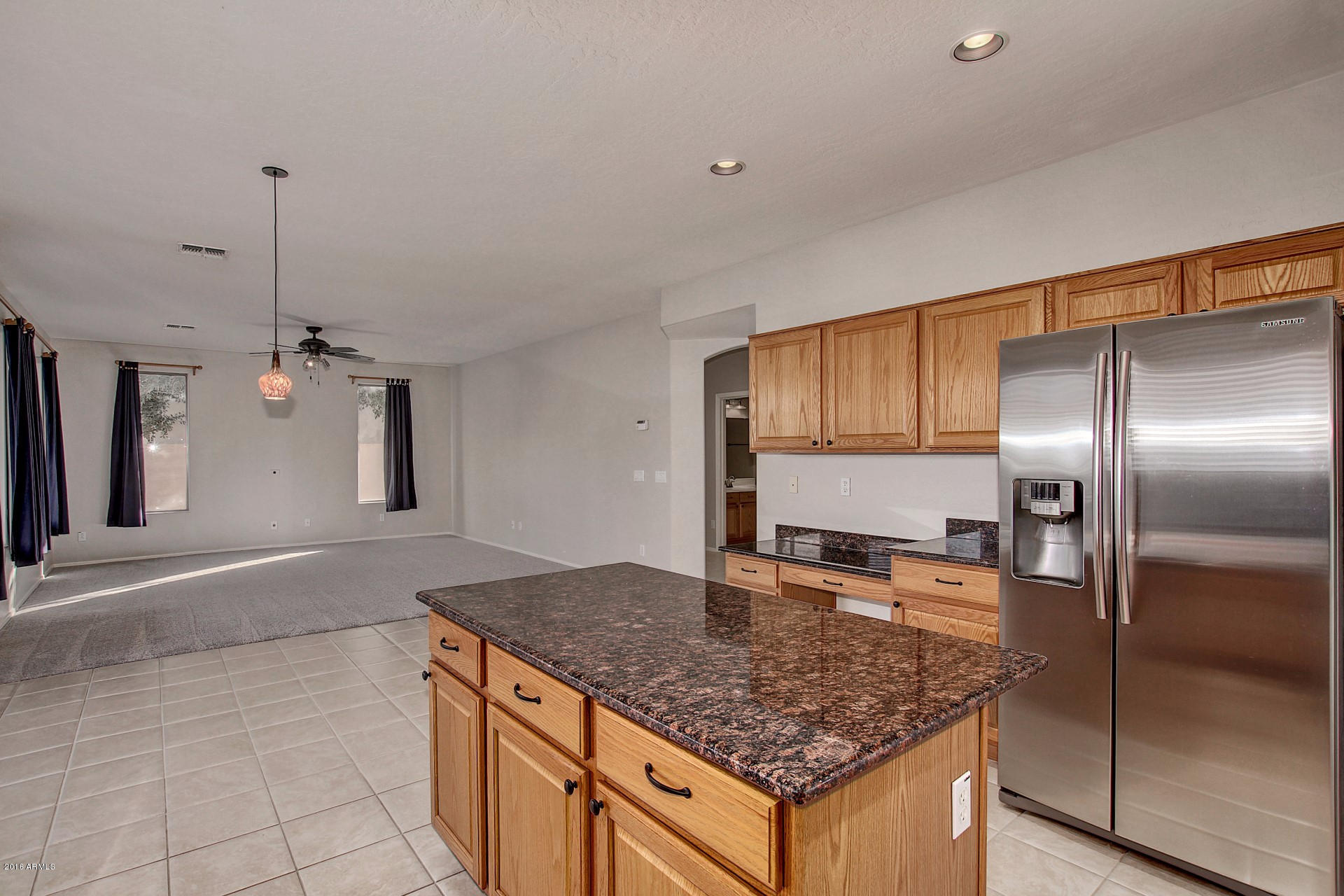 1360 East Harrison Street Gilbert, AZ 85295 - Photo 9 of 34 a kitchen with stainless steel appliances granite countertop a sink and a refrigerator
