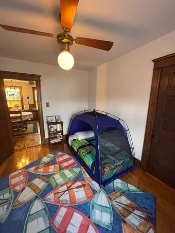 a living room filled with furniture and a baby crib