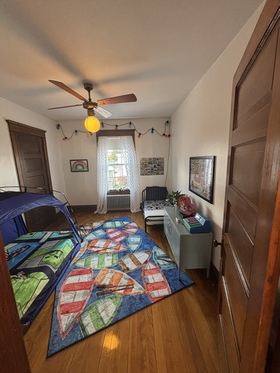 460 Burncoat Street, Unit B Worcester, MA 01606 - Photo 17 of 19 a living room filled with furniture and a baby crib