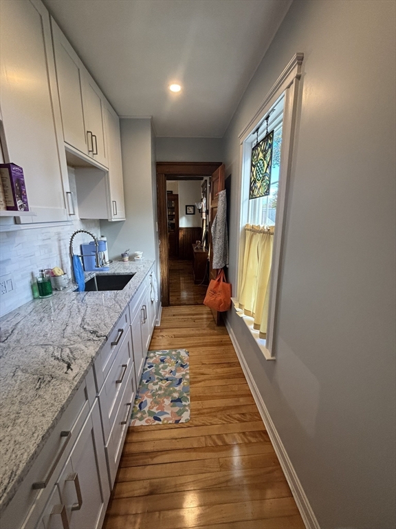 460 Burncoat Street, Unit B Worcester, MA 01606 - Photo 6 of 19 a hallway with seating area and hardwood floor