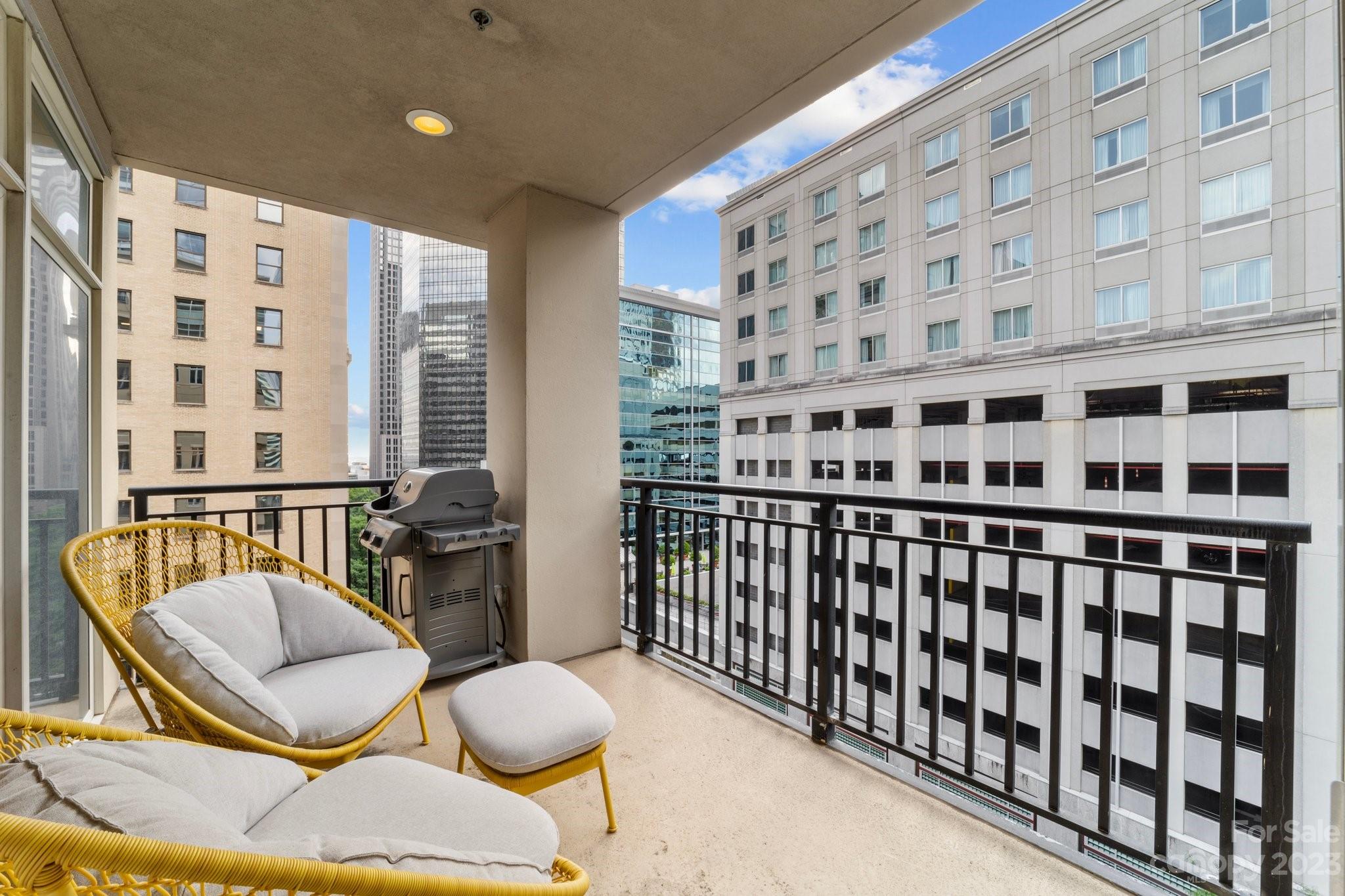 230 South Tryon Street, Unit 906 Charlotte, NC 28202 - Photo 11 of 27 a view of a balcony with chairs