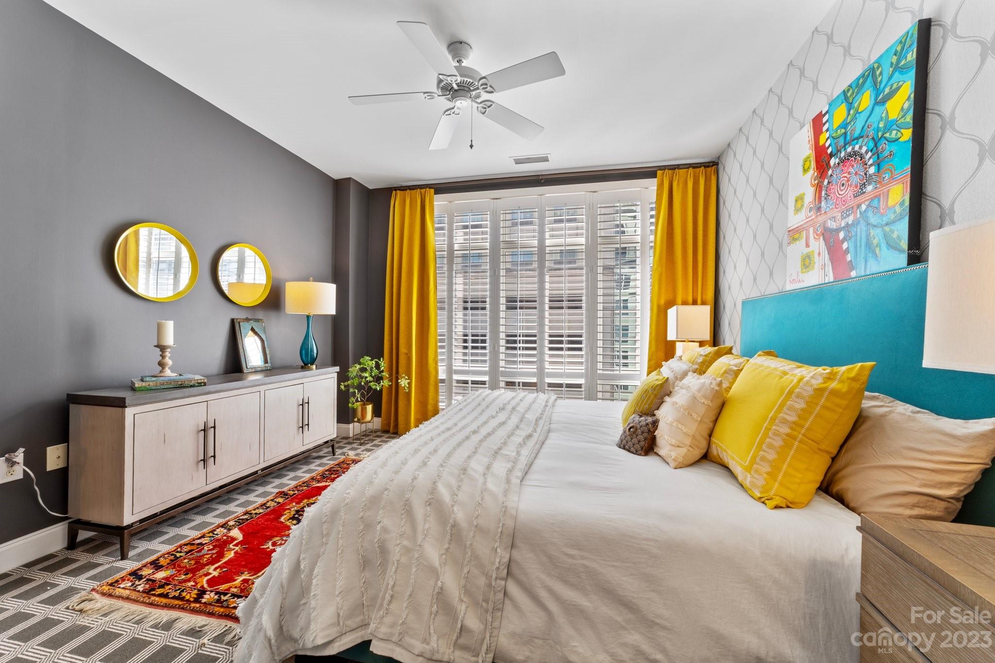 230 South Tryon Street, Unit 906 Charlotte, NC 28202 - Photo 12 of 27 a bedroom with a bed and a large window