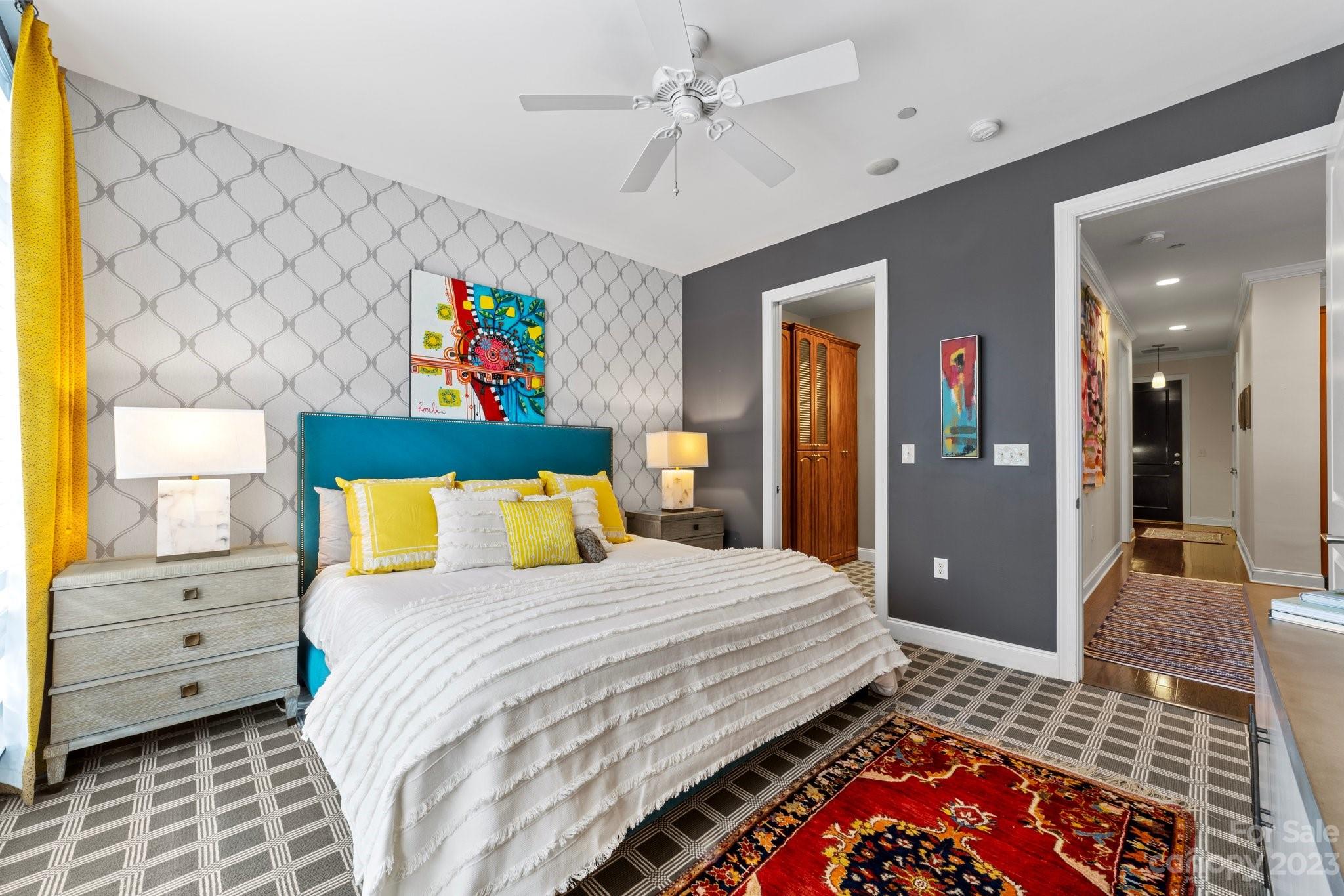 230 South Tryon Street, Unit 906 Charlotte, NC 28202 - Photo 13 of 27 a bedroom with a bed and a painting on the wall